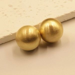 Golden ball earring.